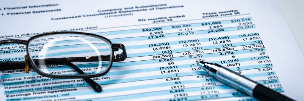 income statement with glasses and pen