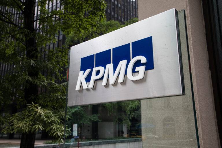 KPMG accounting firm logo on building sign