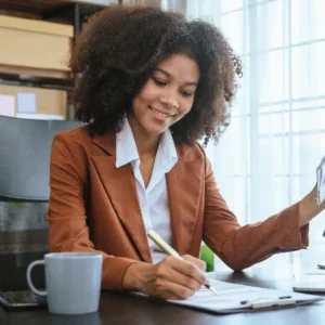 Businesswoman smiling while working at her desk