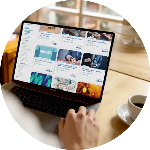 Man browsing Western CPE course catalogue at a cafe with coffee