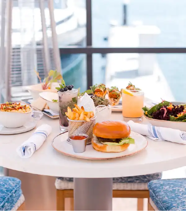 Burger and salad with a view of the water