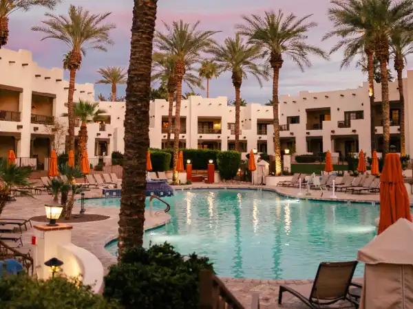 Outdoor pool with palms at sunset