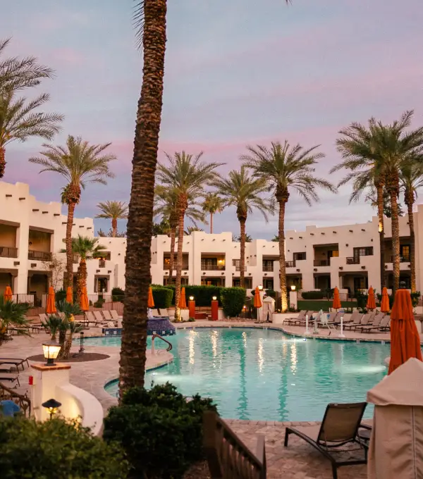 Outdoor pool with palms at sunset