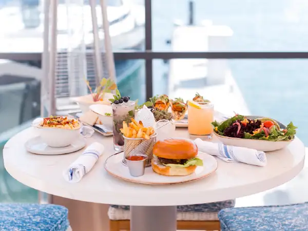 Burger and salad with a view of the water