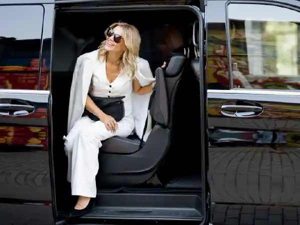 Woman in sunglasses stepping out of a shuttle