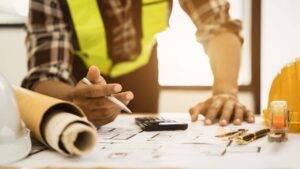 Construction contractor running numbers.