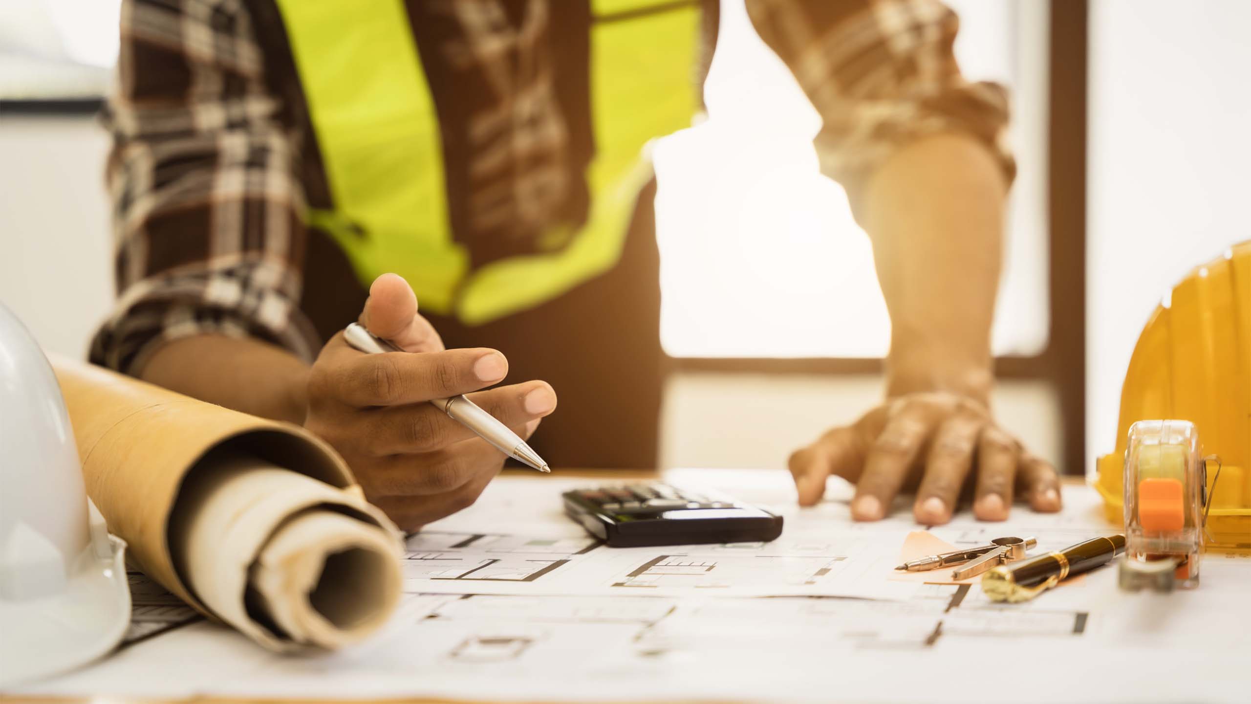 Construction contractor running numbers.