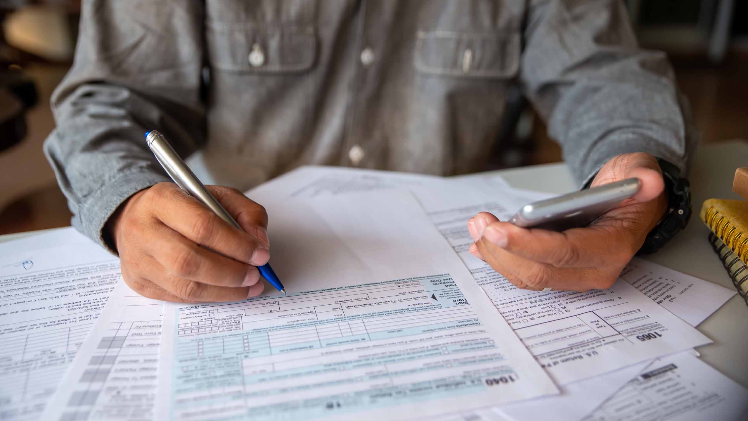 Taxpayer filing out a 1040 form.