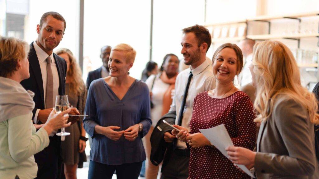 Professionals networking at an event.