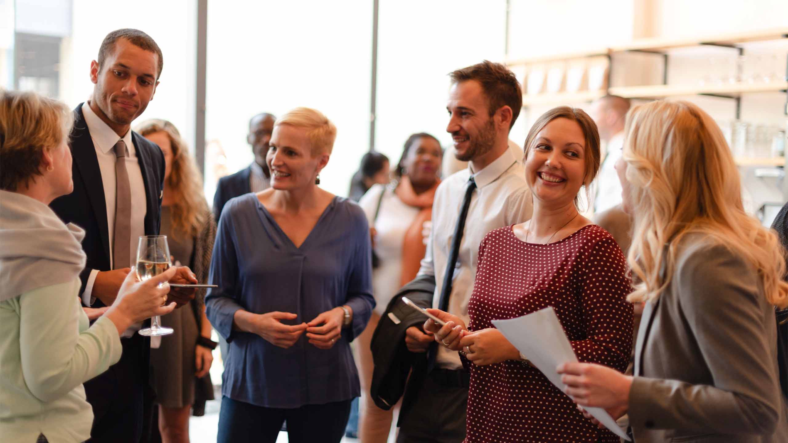 Professionals networking at an event.