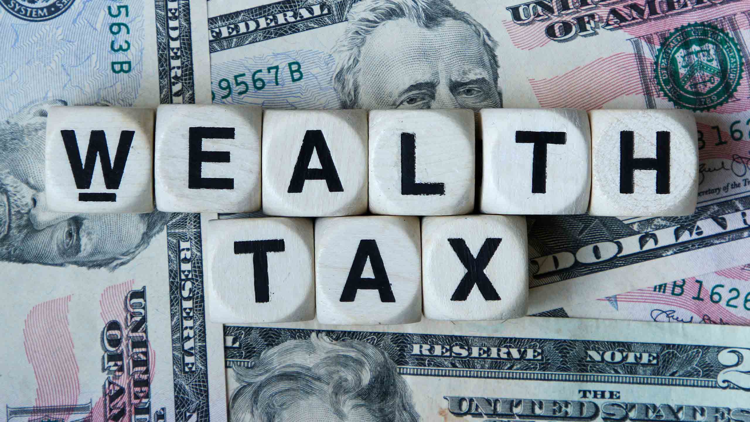 Dice spelling out wealth tax.