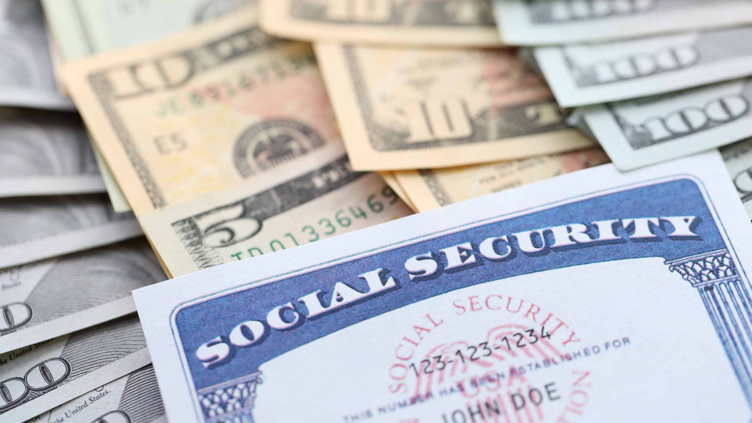 American US dollars money bills and US social security number card close up